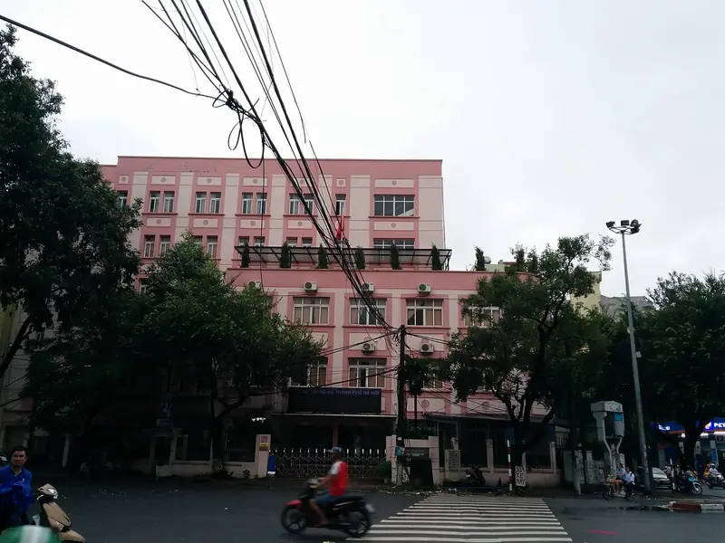 Dusty pink building seen from the street in Hanoi, Vietnam