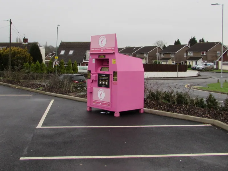 Bright pink donation bin in a supermarket car park, Caldicot, Wales